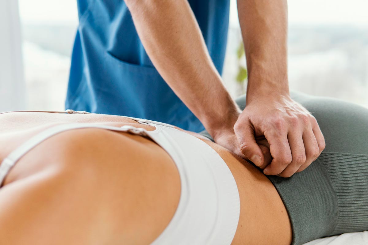 osteopath seeing patient for lower back pain